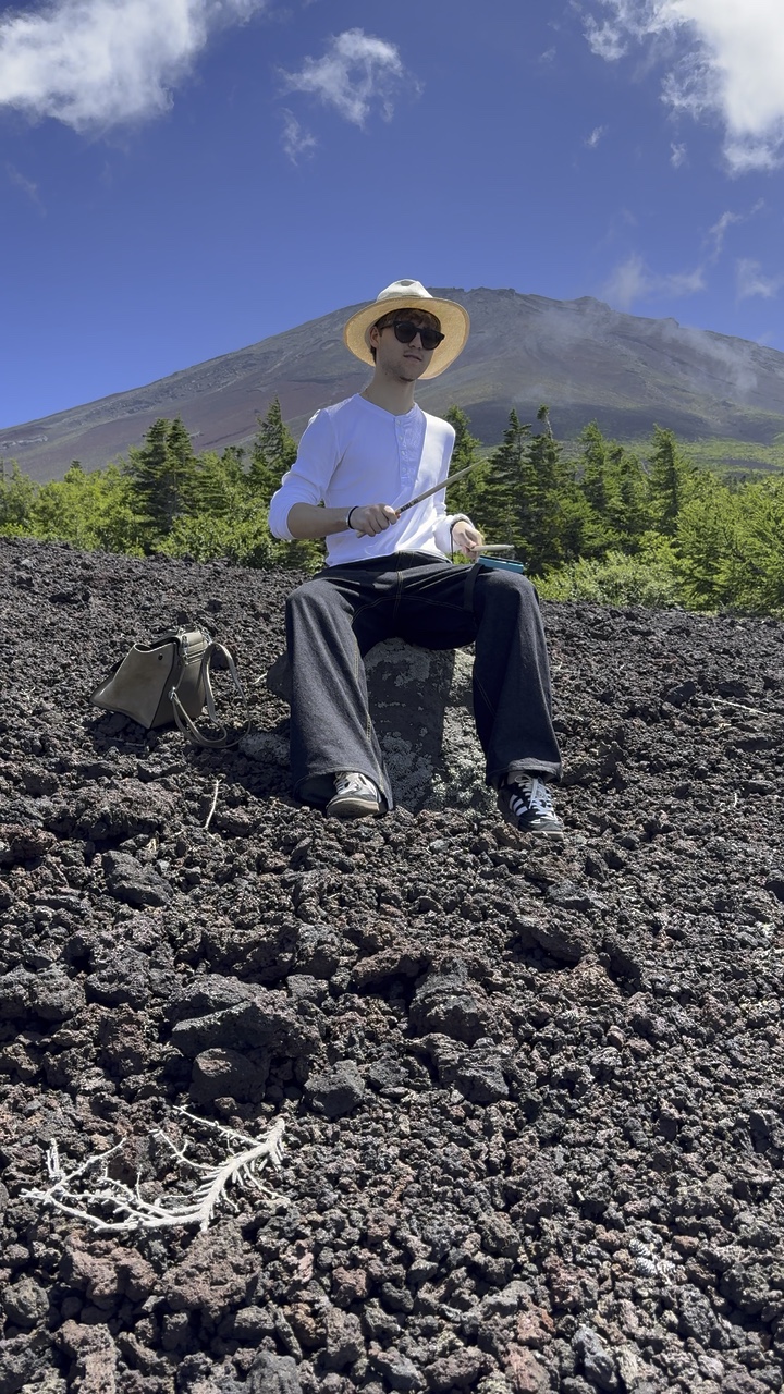 Timothei practising with drumsticks at Mount Fuji
