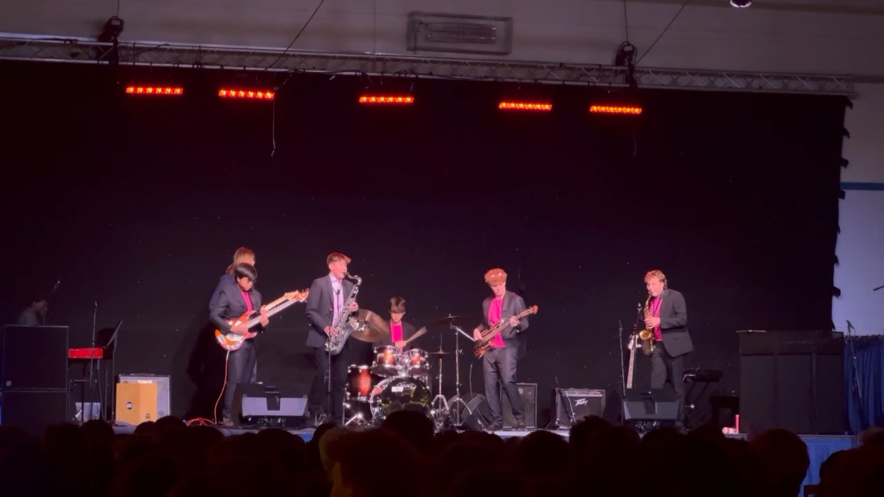 Timothei Farr on drums with a live band and saxophonists