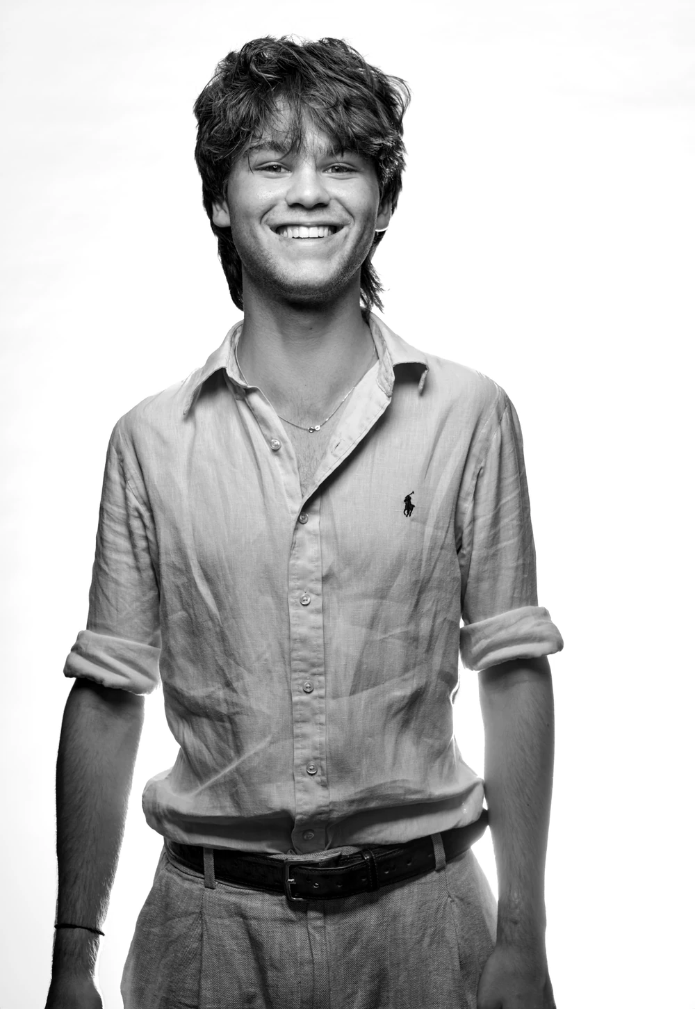 Timothei Farr smiling in an open-collar shirt